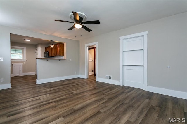 514 Hamilton Ave, Wood River, IL 62095 - unfurnished living room with ceiling fan, dark wood-style flooring, and baseboards