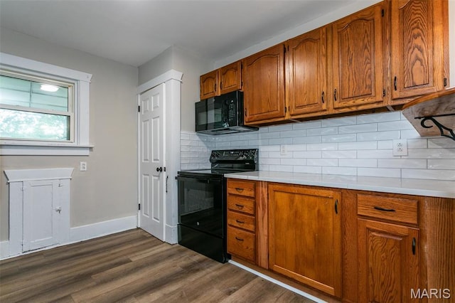 514 Hamilton Ave, Wood River, IL 62095 - kitchen with black appliances, dark wood finished floors, brown cabinets, light countertops, and backsplash