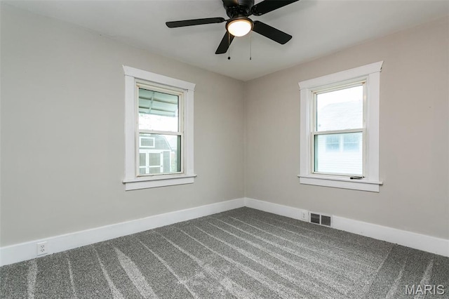 514 Hamilton Ave, Wood River, IL 62095 - empty room with dark colored carpet, healthy amount of natural light, baseboards, and ceiling fan