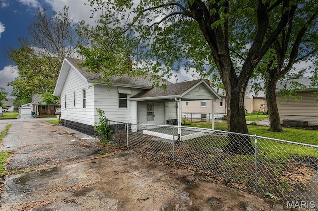 514 Hamilton Ave, Wood River, IL 62095 - view of front of home with driveway, roof with shingles, and a gate