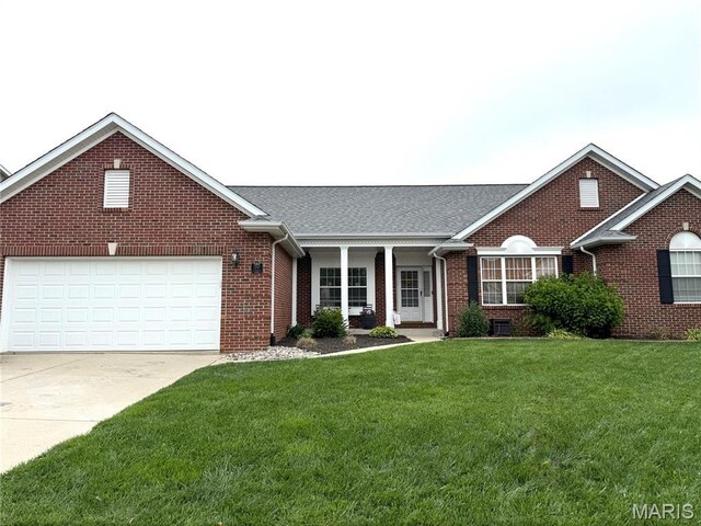 1247 Elisabeth Dr, Ofallon, IL 62269 - view of front facade featuring brick siding, a front yard, concrete driveway, a garage, and a shingled roof