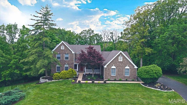 1437 Neffwold Ln, Saint Louis, MO 63122 - traditional-style house with brick siding, a front yard, and a porch