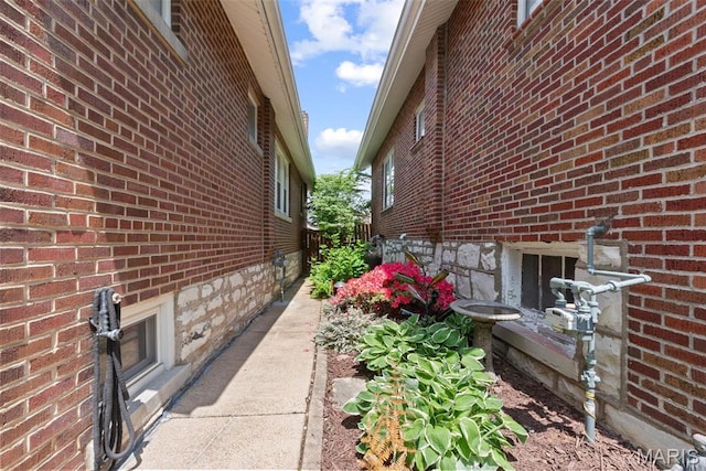 view of side of property featuring brick siding