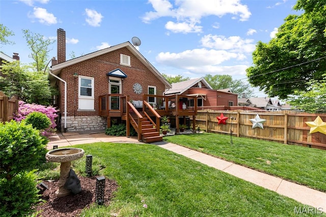 back of property with brick siding, a deck, a chimney, and stairway