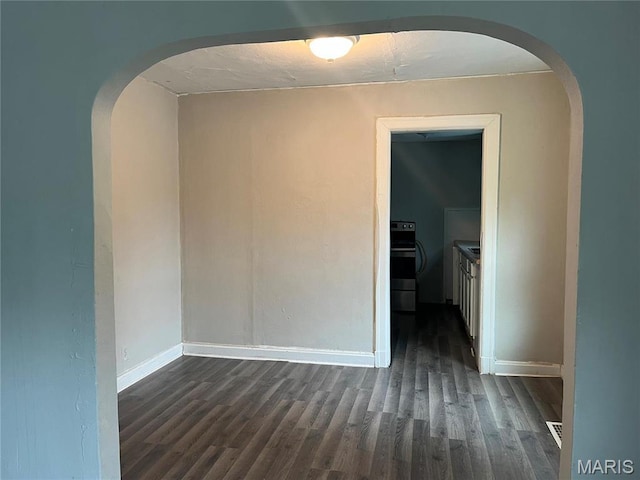 2123 Rosebud Ave, Hillsdale, MO 63121 - unfurnished room featuring arched walkways, dark wood finished floors, and baseboards