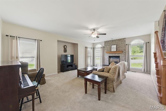 65 Snowberry Ridge Ct, Ofallon, MO 63366 - living area featuring light carpet, ceiling fan, a large fireplace, and baseboards