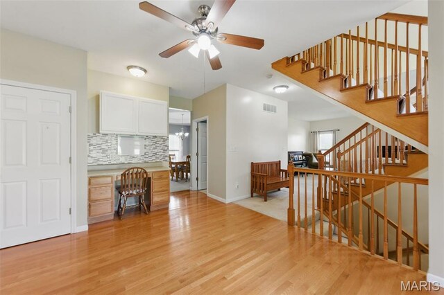 65 Snowberry Ridge Ct, Ofallon, MO 63366 - living room featuring light wood-style floors, ceiling fan, stairway, and baseboards