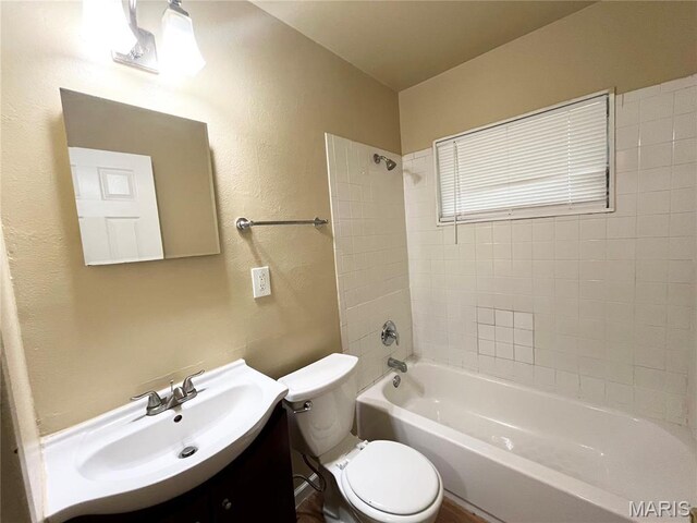1688 Maldon Ln, Saint Louis, MO 63136 - full bathroom with toilet, bathing tub / shower combination, vanity, and a textured wall