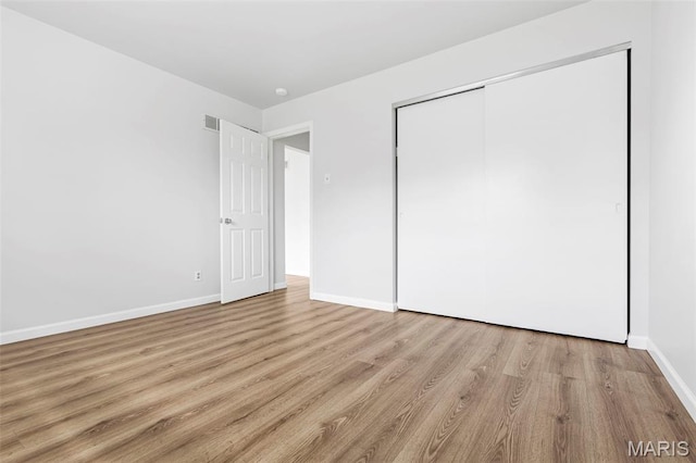 3401 Droste Rd, Saint Charles, MO 63301 - unfurnished bedroom with light wood-type flooring, baseboards, and a closet