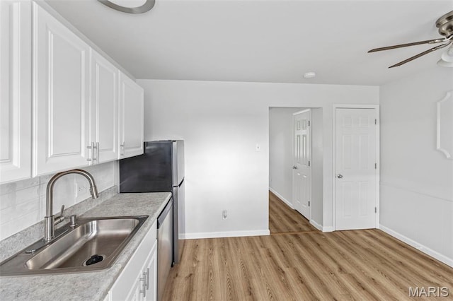 3401 Droste Rd, Saint Charles, MO 63301 - kitchen featuring a sink, ceiling fan, light wood finished floors, white cabinets, and light countertops