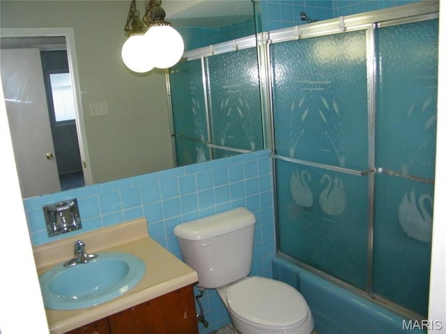 574 Coach Light Ln, Hazelwood, MO 63042 - full bath featuring vanity, toilet, enclosed tub / shower combo, and tile walls