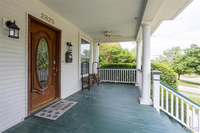 wooden deck with a porch and ceiling fan