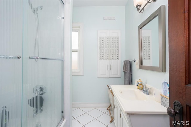 bathroom with tile patterned floors, a shower stall, vanity, and baseboards