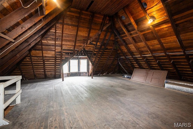 unfinished attic with an upstairs landing