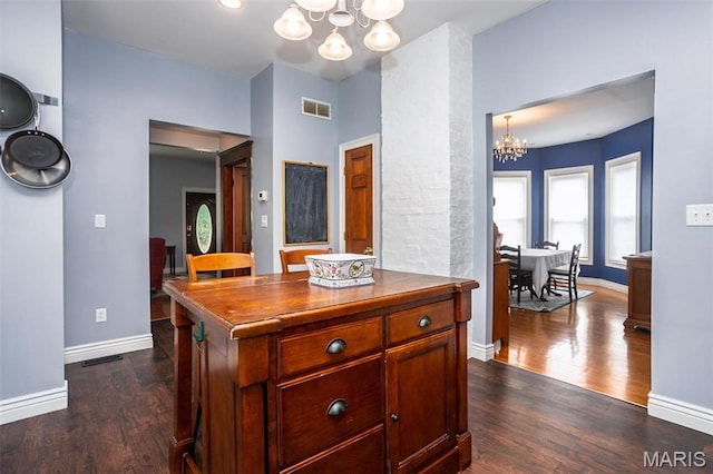 kitchen with a chandelier, dark wood-style floors, baseboards, and decorative light fixtures