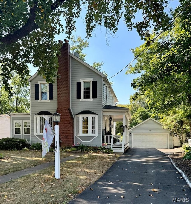 149 N Elizabeth Ave, Saint Louis, MO 63135 - traditional-style house with an outdoor structure, a detached garage, a chimney, and covered porch