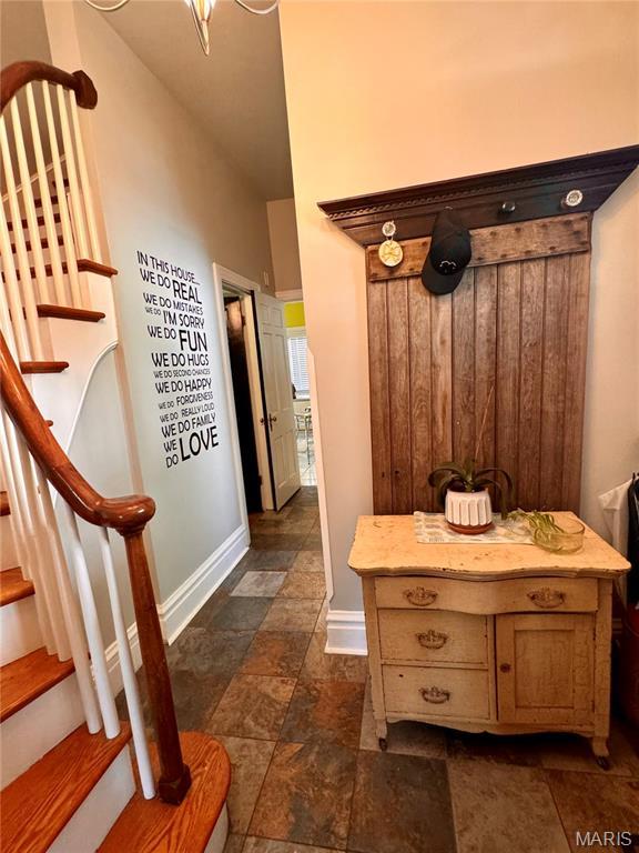 149 N Elizabeth Ave, Saint Louis, MO 63135 - mudroom featuring stone tile floors and baseboards
