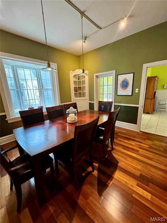 149 N Elizabeth Ave, Saint Louis, MO 63135 - dining room with track lighting, hardwood / wood-style floors, and baseboards