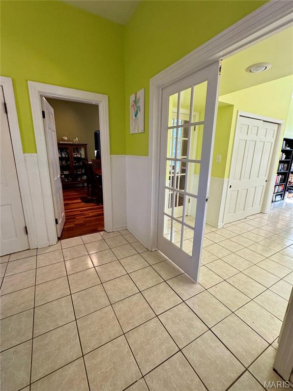 149 N Elizabeth Ave, Saint Louis, MO 63135 - hall featuring light tile patterned flooring and wainscoting