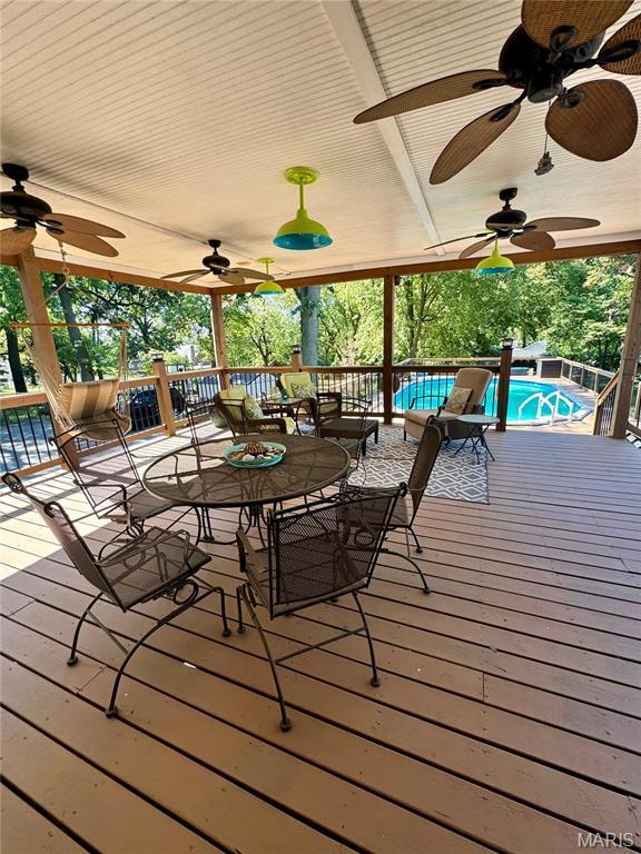 149 N Elizabeth Ave, Saint Louis, MO 63135 - deck featuring a ceiling fan, an outdoor pool, and outdoor dining space