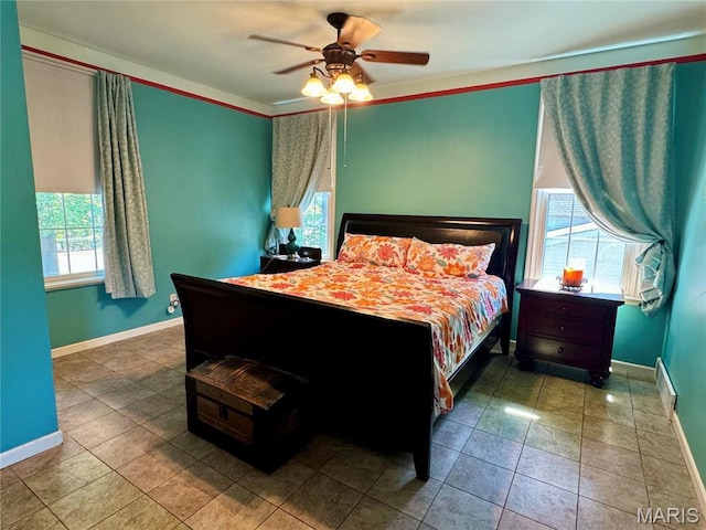 149 N Elizabeth Ave, Saint Louis, MO 63135 - bedroom with multiple windows, baseboards, a ceiling fan, and tile patterned flooring