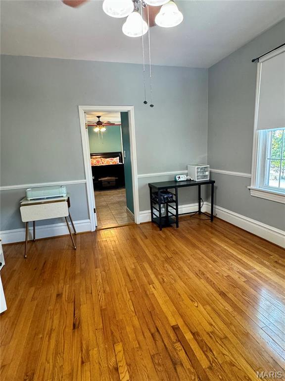 149 N Elizabeth Ave, Saint Louis, MO 63135 - spare room featuring wood-type flooring, a ceiling fan, and baseboards