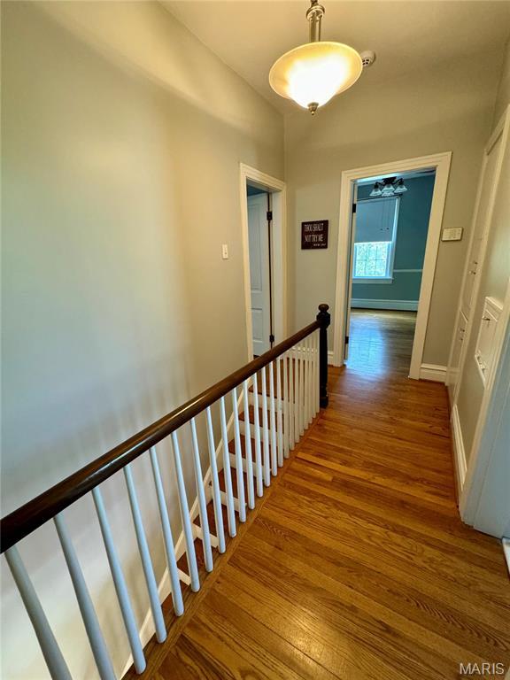 149 N Elizabeth Ave, Saint Louis, MO 63135 - hall with an upstairs landing, wood finished floors, and baseboards