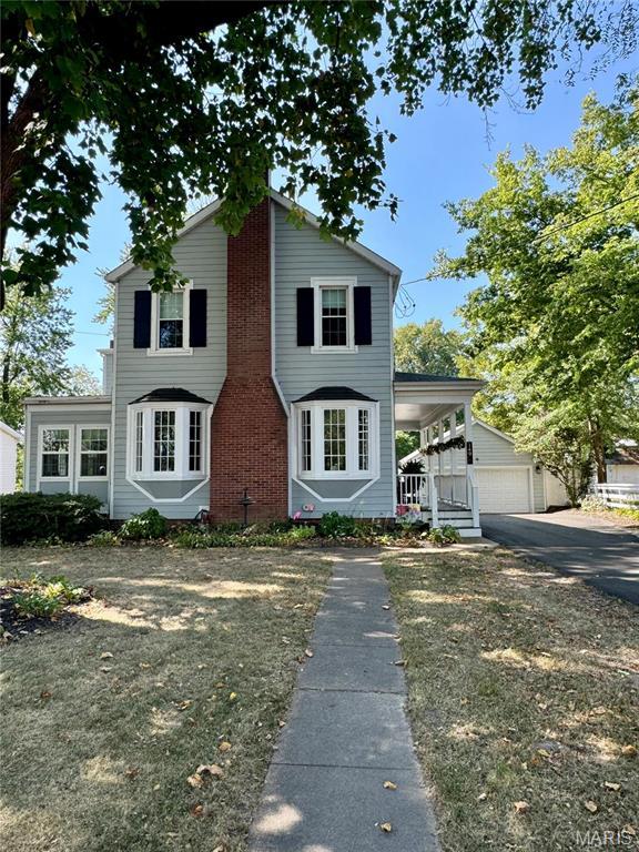 149 N Elizabeth Ave, Saint Louis, MO 63135 - view of front of home with covered porch and brick siding