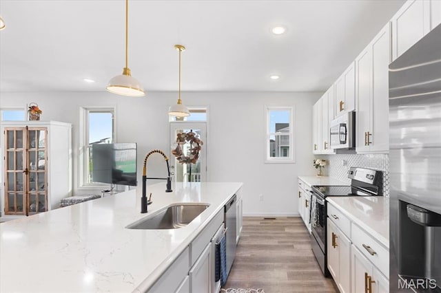 2032 Tiber St, Saint Charles, MO 63301 - kitchen featuring stainless steel appliances, a sink, recessed lighting, white cabinets, and decorative light fixtures