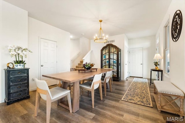 2032 Tiber St, Saint Charles, MO 63301 - dining room featuring wood finished floors, a chandelier, stairway, and baseboards
