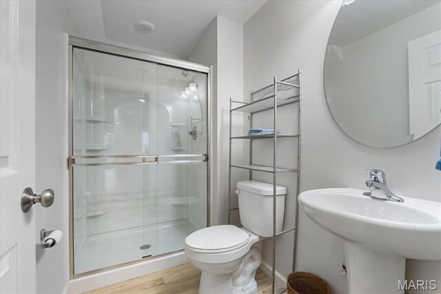 2032 Tiber St, Saint Charles, MO 63301 - bathroom featuring toilet, a shower stall, wood finished floors, and a sink