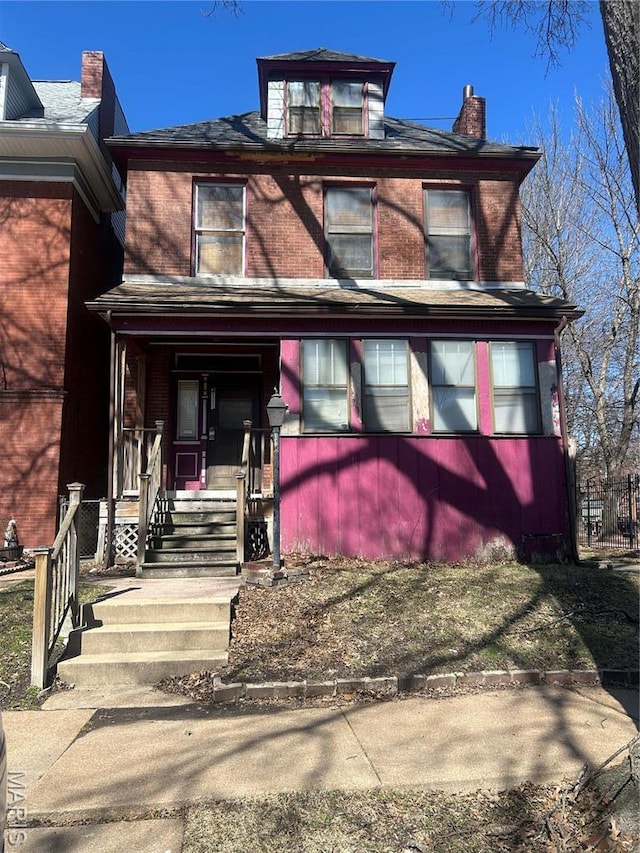 4111 Cleveland Ave, Saint Louis, MO 63110 - american foursquare style home featuring brick siding, a porch, and a chimney