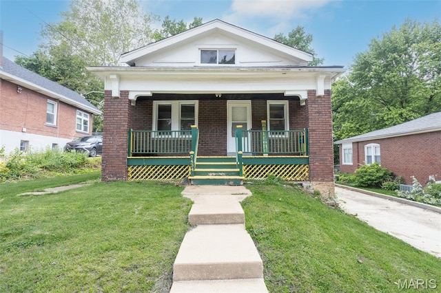 7434 Gayola Pl, Saint Louis, MO 63143 - view of front of home featuring brick siding, a porch, and a front yard
