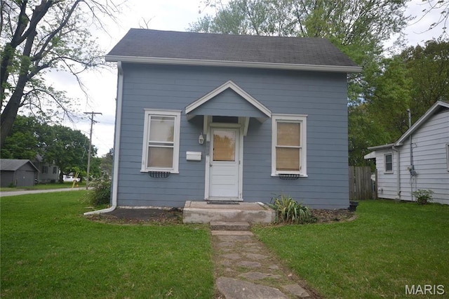103 N Delaware Ave, Belleville, IL 62221 - shotgun-style home with a front lawn and a shingled roof