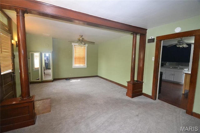 103 N Delaware Ave, Belleville, IL 62221 - unfurnished living room with ceiling fan, decorative columns, and carpet floors