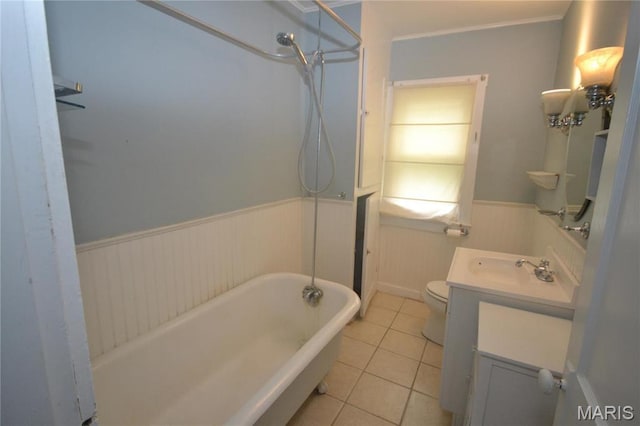 103 N Delaware Ave, Belleville, IL 62221 - full bath featuring vanity, wainscoting, tile patterned flooring, a tub, and toilet