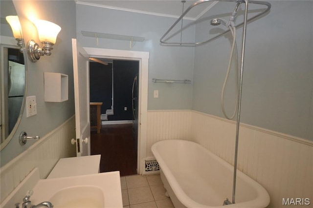 103 N Delaware Ave, Belleville, IL 62221 - full bath featuring wainscoting, a freestanding bath, a sink, tile patterned flooring, and a shower