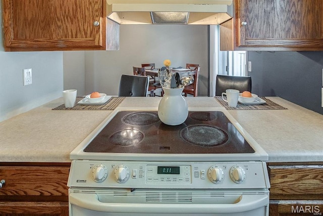 1811 Ramada Blvd Unit 6, Collinsville, IL 62234 - kitchen featuring electric range, range hood, brown cabinetry, and light countertops