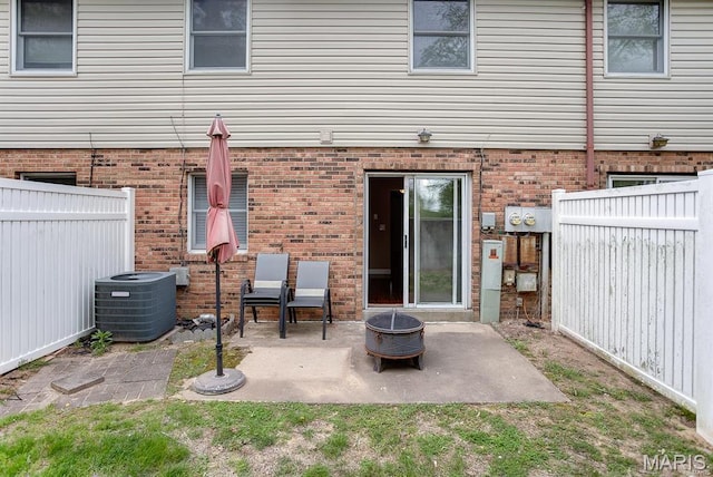 1811 Ramada Blvd Unit 6, Collinsville, IL 62234 - rear view of house with central AC unit, a patio, a fire pit, a fenced backyard, and brick siding