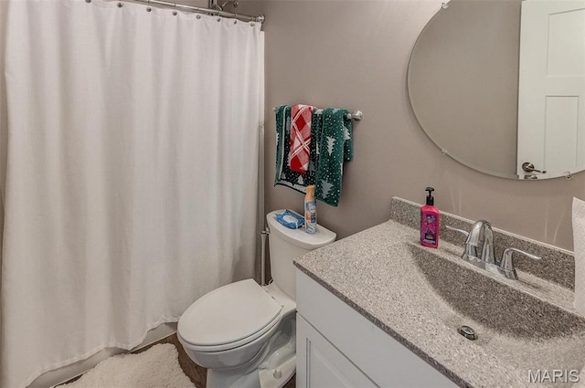 bathroom with toilet, vanity, and a shower with shower curtain