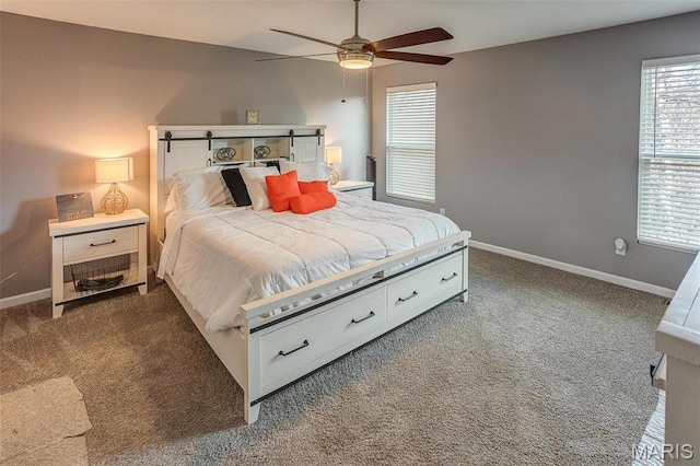 bedroom with dark colored carpet, baseboards, and ceiling fan
