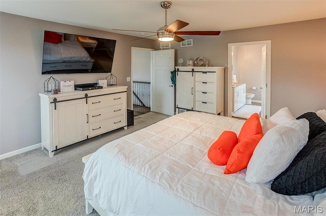 bedroom with light carpet, ceiling fan, baseboards, and ensuite bathroom