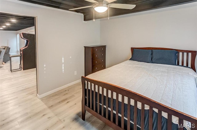 bedroom with wood finished floors, baseboards, and a ceiling fan