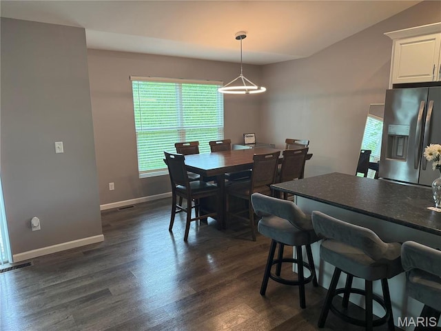 dining area with healthy amount of natural light, dark wood finished floors, and baseboards