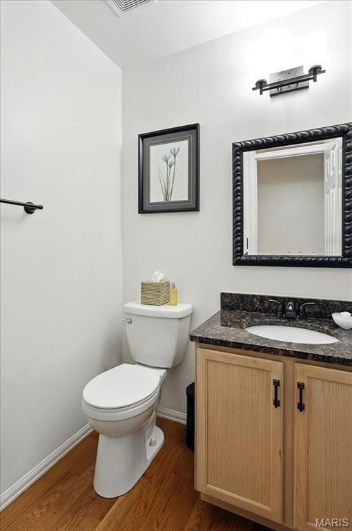 17282 Hilltop Ridge Dr, Eureka, MO 63025 - bathroom with wood finished floors, baseboards, toilet, and vanity