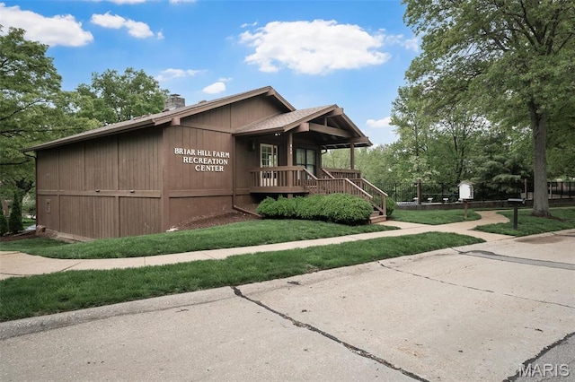 2013 Trailcrest Ln Unit 7, Saint Louis, MO 63122 - view of front of home with a chimney, a porch, a front yard, and stairway
