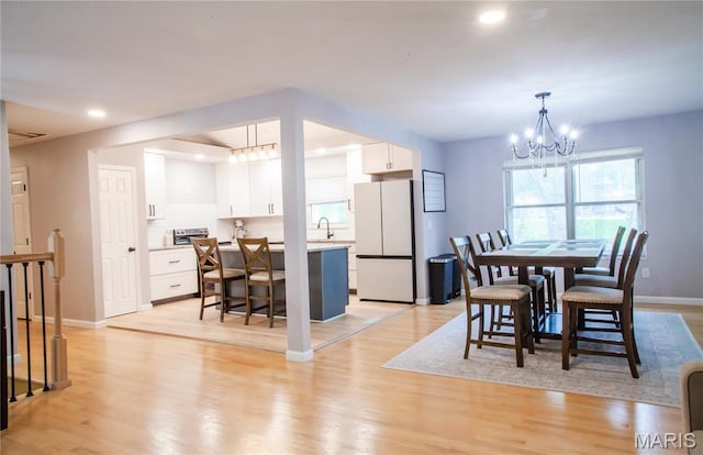 504 Leawood Dr, Swansea, IL 62226 - dining area featuring a chandelier, healthy amount of natural light, light wood-style flooring, and recessed lighting