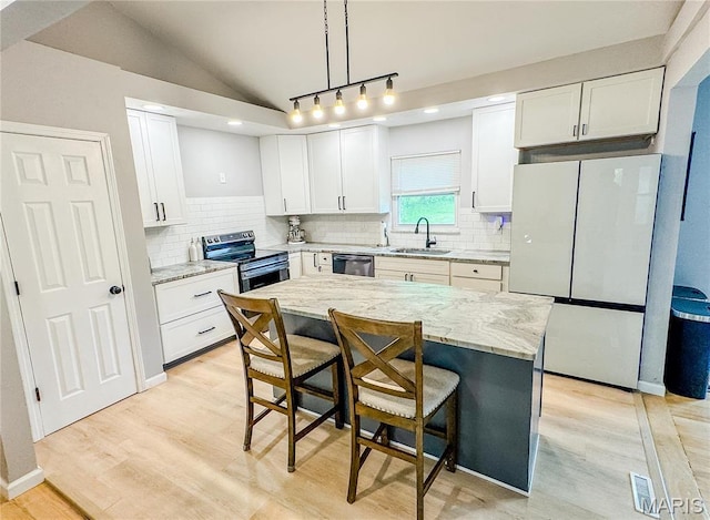 504 Leawood Dr, Swansea, IL 62226 - kitchen with stainless steel appliances, a sink, a breakfast bar, light wood-type flooring, and light stone counters