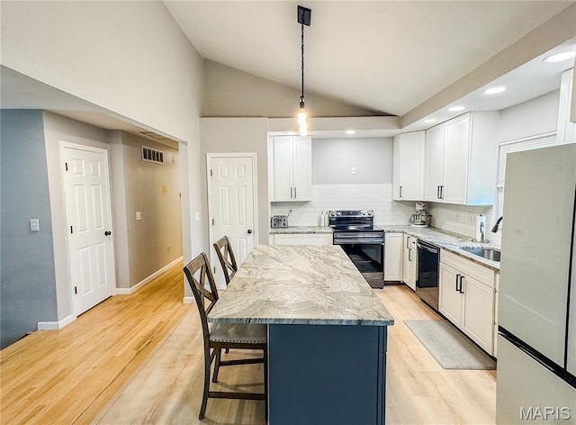 504 Leawood Dr, Swansea, IL 62226 - kitchen with stainless steel electric range, dishwashing machine, freestanding refrigerator, a kitchen island, and a breakfast bar area