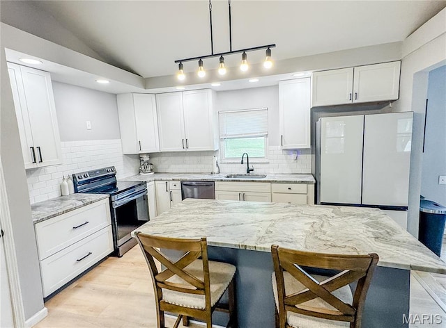 504 Leawood Dr, Swansea, IL 62226 - kitchen featuring appliances with stainless steel finishes, a sink, a kitchen breakfast bar, light stone countertops, and white cabinets